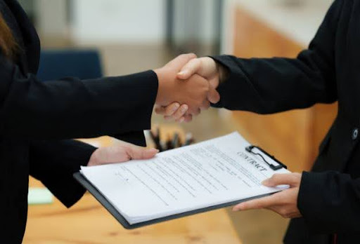 business deal over clipboard