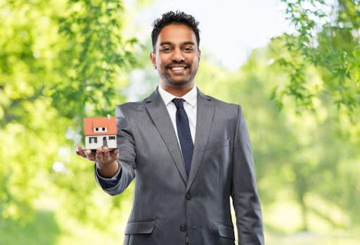 real estate agent holding little house