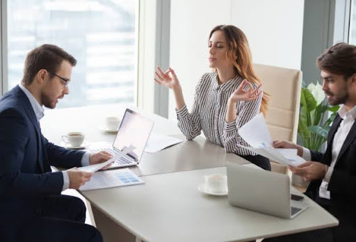 three real estate agents working at desk